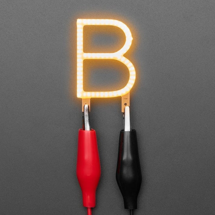 Alphabet LED Filament - This warm-white glowy letter is made out of COB (chip on board) LEDs, often seen in 'Edison-like' LED bulbs, arranged in different patterns to give a bright, warm lighting effect.