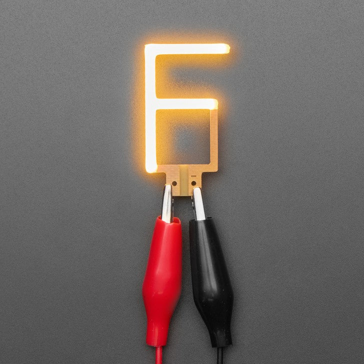 Alphabet LED Filament - This warm-white glowy letter is made out of COB (chip on board) LEDs, often seen in 'Edison-like' LED bulbs, arranged in different patterns to give a bright, warm lighting effect.