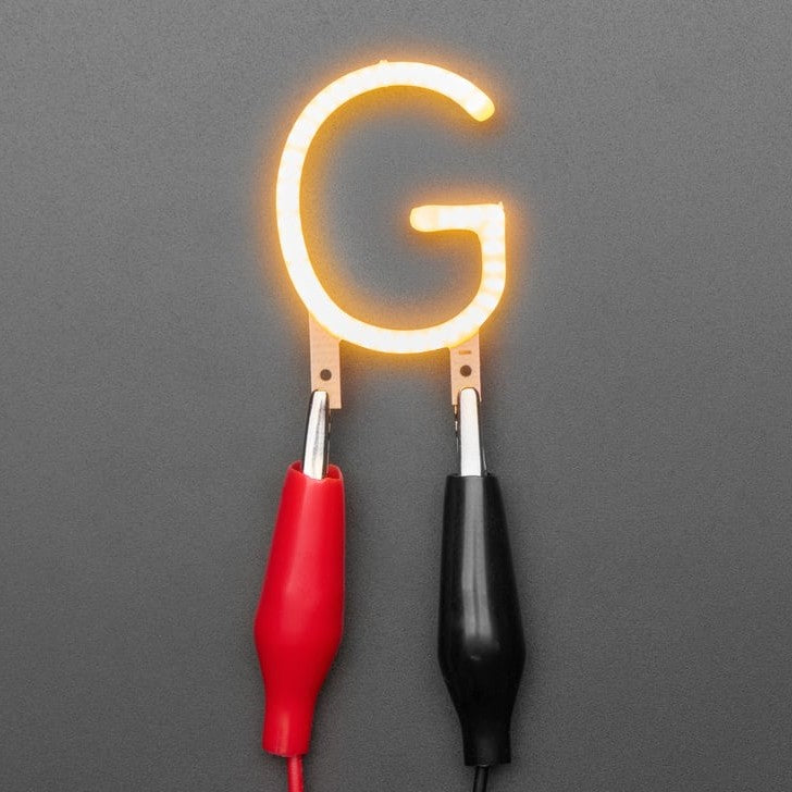 Alphabet LED Filament - This warm-white glowy letter is made out of COB (chip on board) LEDs, often seen in 'Edison-like' LED bulbs, arranged in different patterns to give a bright, warm lighting effect.