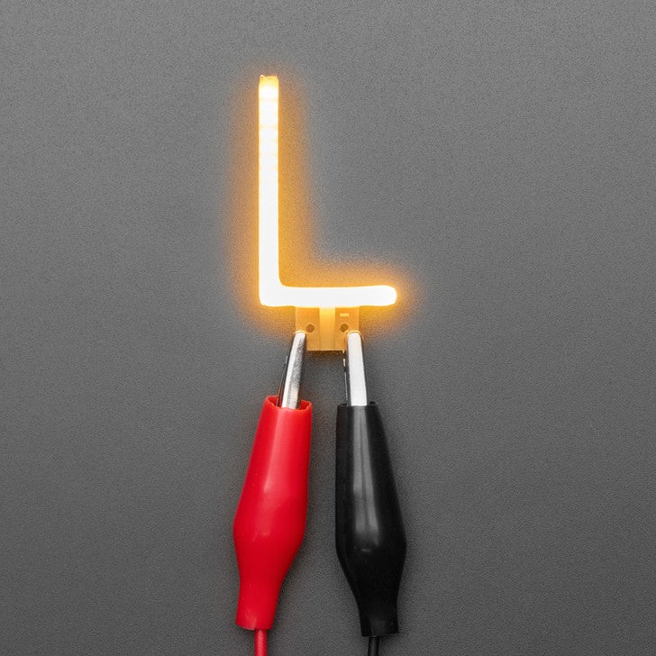 Alphabet LED Filament - This warm-white glowy letter is made out of COB (chip on board) LEDs, often seen in 'Edison-like' LED bulbs, arranged in different patterns to give a bright, warm lighting effect.