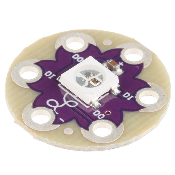 LilyPad Pixel Board - We know you love adding color to your e-textiles, adding the LilyPad Pixel Board to your project will only make it better. The pixel board is equipped with a WS2812B which is actually an RGB LED with a WS2811 built right into the LED!