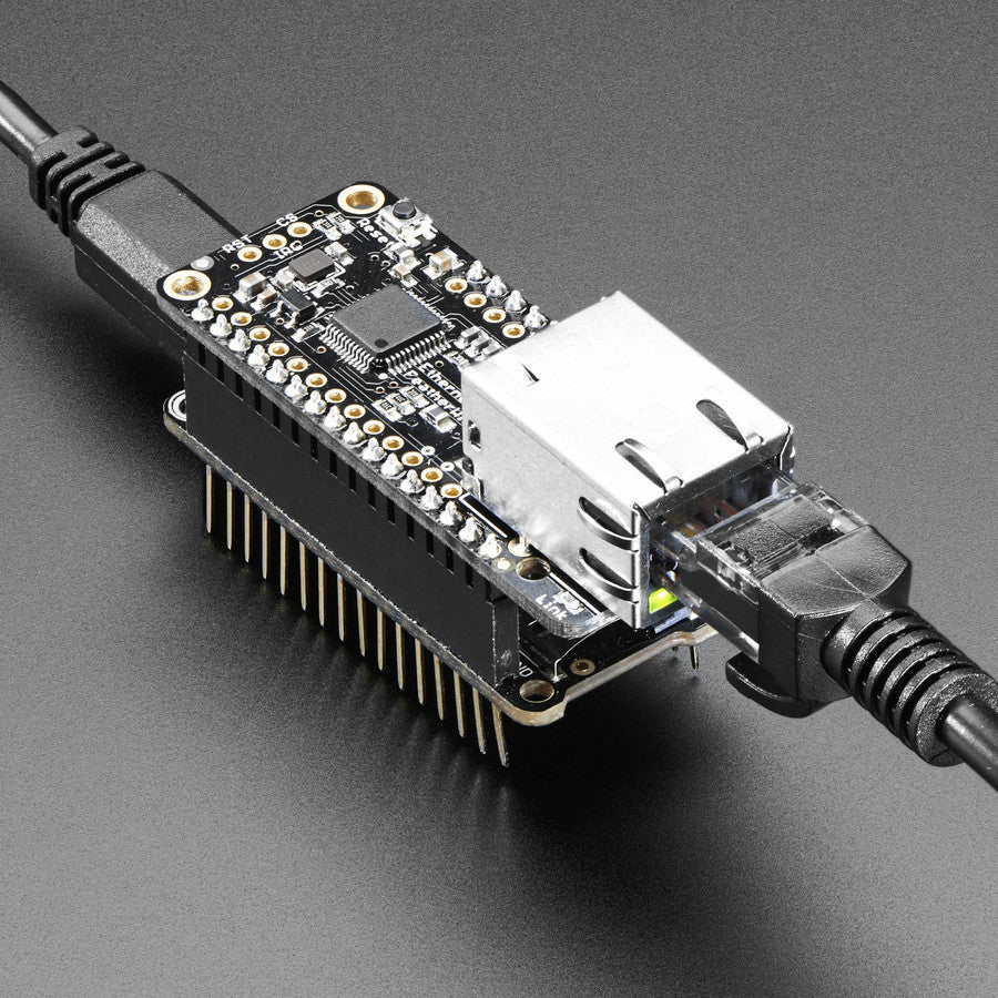 Adafruit Ethernet FeatherWing - Wireless is wonderful, but sometimes you want the strong reliability of a wire. If your Feather board is going to be part of a permanent installation, this Ethernet FeatherWing will let you add quick and easy wired Internet.