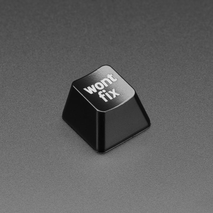 Etched Glow-Through Keycap with "wont fix" Text - MX Compatible Switches - It's not a bug, it's a feature! Make quick work of your Pivotals or assigned issue with a click of a button thanks to this super-classy and custom-made wont fix Etched Keycap. It's certain to spark delightful conversations about how awful you are for not acceding to every demand.