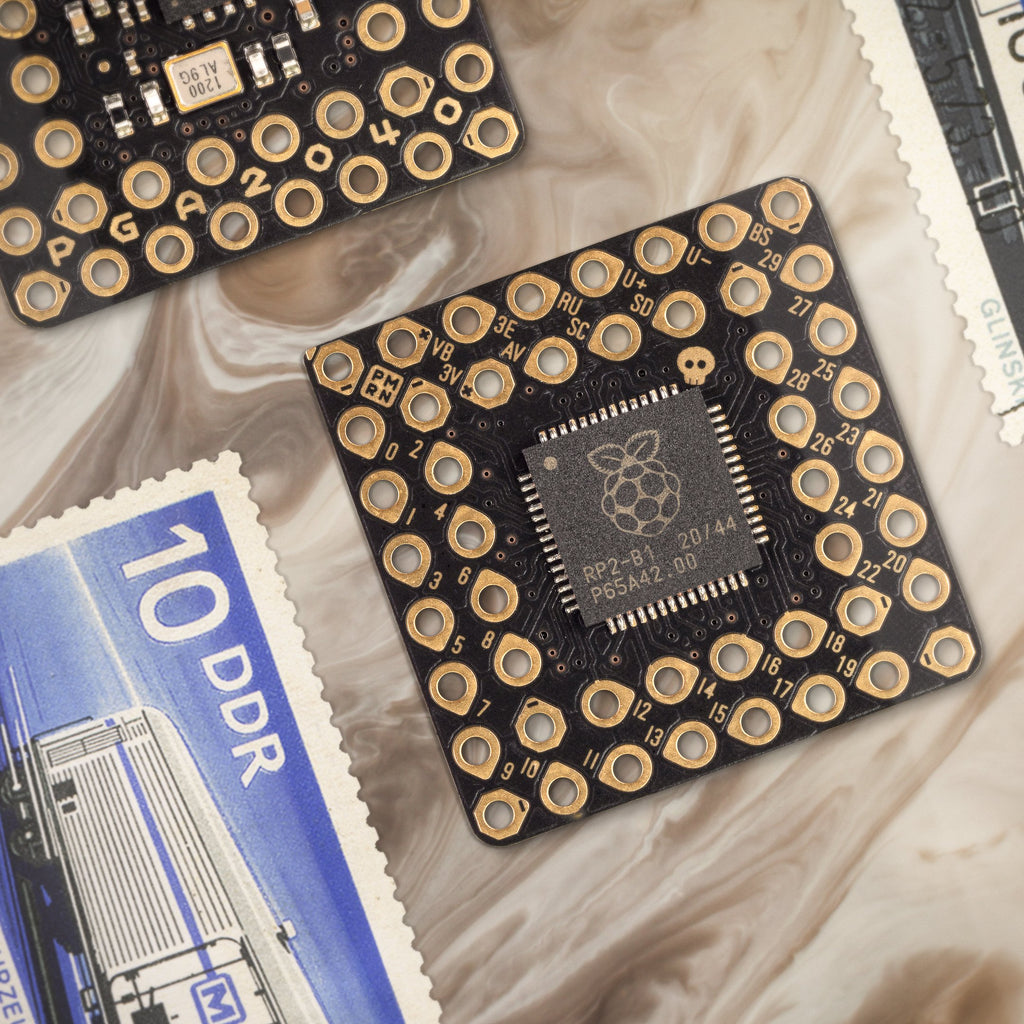PGA2040 - A minimal RP2040 breakout board wrangled into a Pin Grid Array, with 8MB flash and a maximal dash of retraux style.